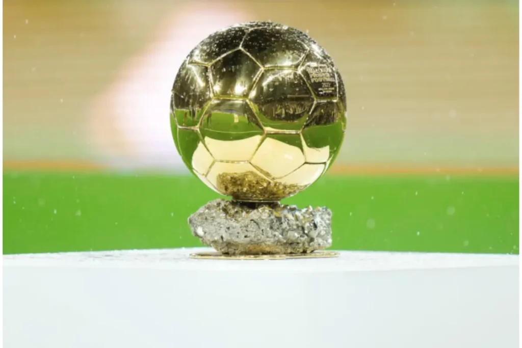 he Ballon d'Or trophy placed on a pedestal, symbolizing the highest individual honor in football.