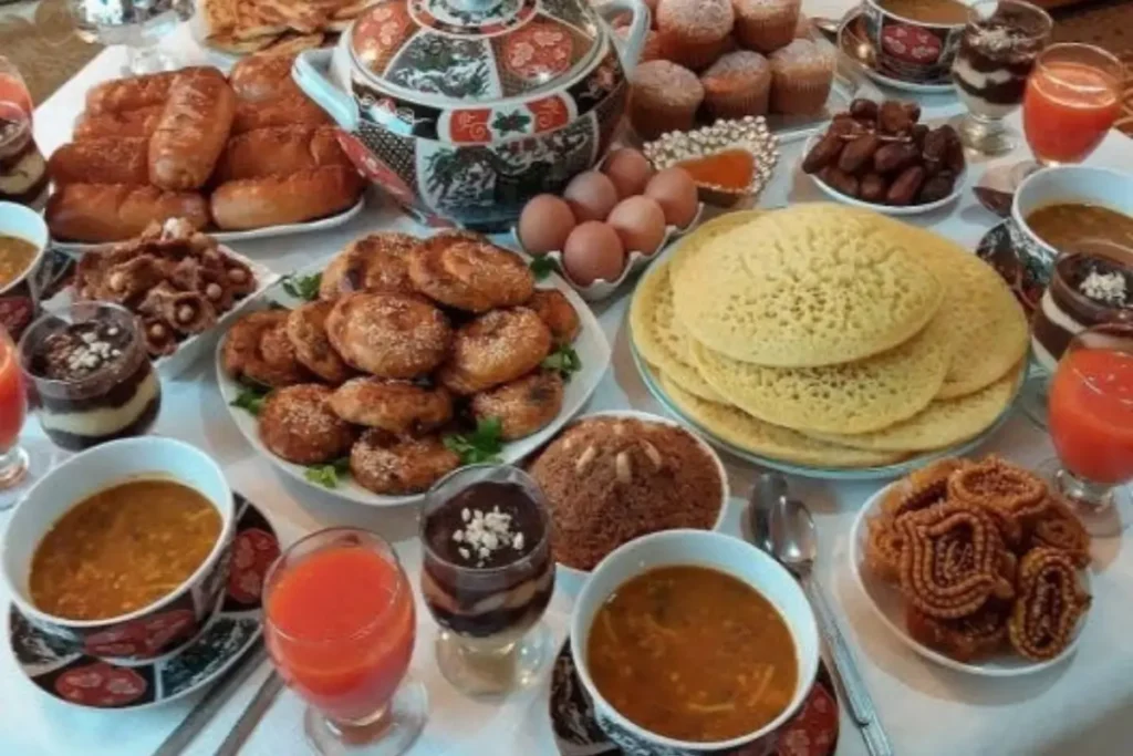 Traditional Moroccan Fetour table for Ramadan with harira soup, dates, chebakia, boiled eggs, and Moroccan bread, as featured in The Ultimate Guide to Moroccan Cuisine.