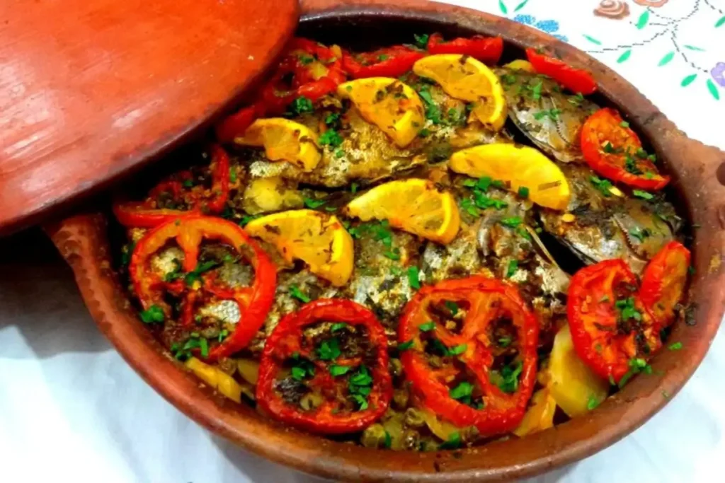 Traditional Moroccan tagine with fish ,tomatoes, peppers, and chermoula