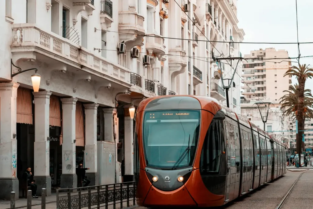 Modern tram in downtown Casablanca, Morocco, passing historic buildings during AFCON 2025 travel season.