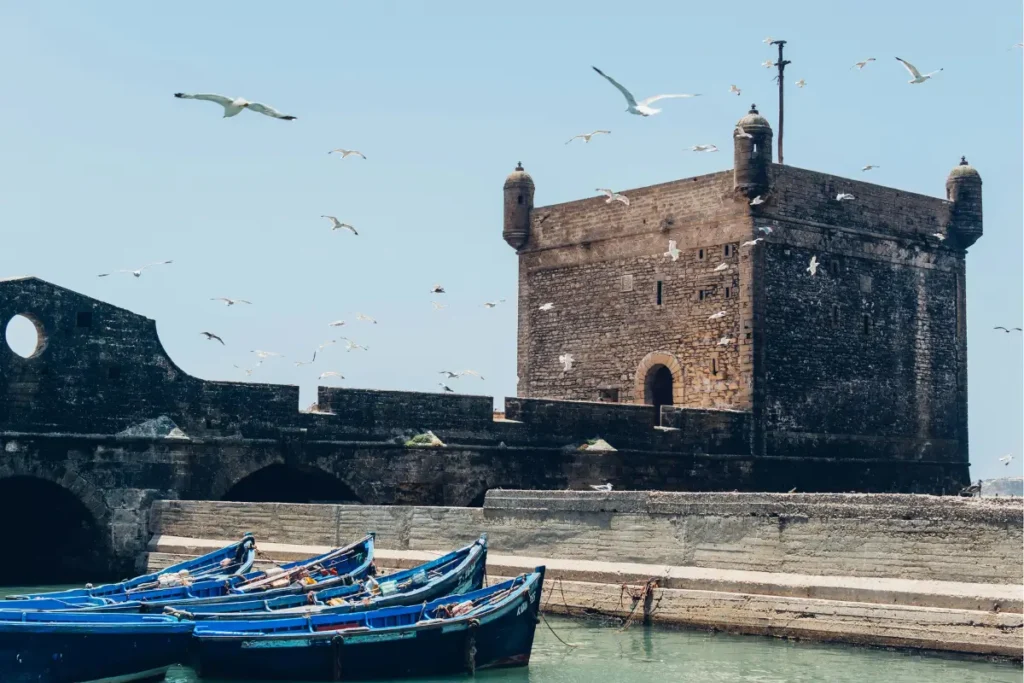 Scenic view of Essaouira’s historic medina and Atlantic coastline with fishing boats in the harbor