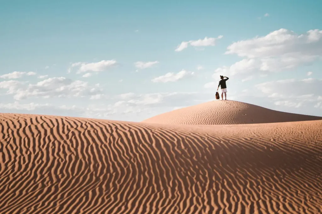 Expansive Sahara Desert dunes near Dakhla, Morocco under a clear blue sky