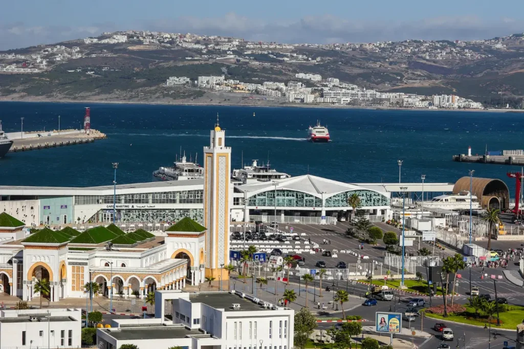 Panoramic view of Tangier, Morocco featuring whitewashed buildings, the Strait of Gibraltar, and the historic medina
