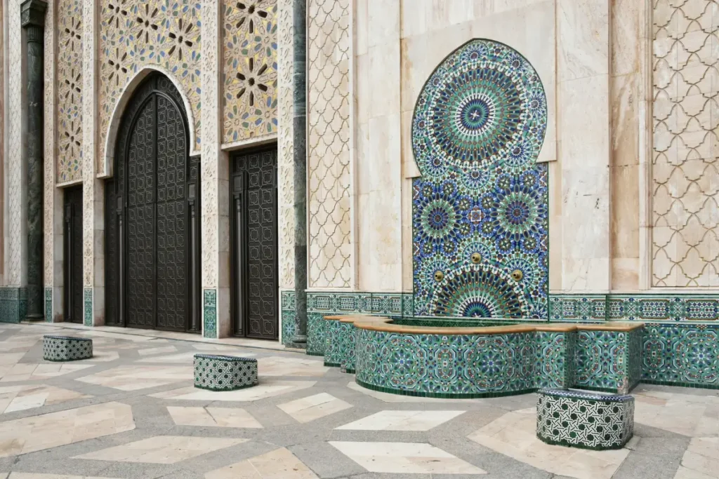 Exterior view of Hassan II Mosque in Casablanca, Morocco, showcasing intricate Islamic architecture and the world's second-tallest minaret.